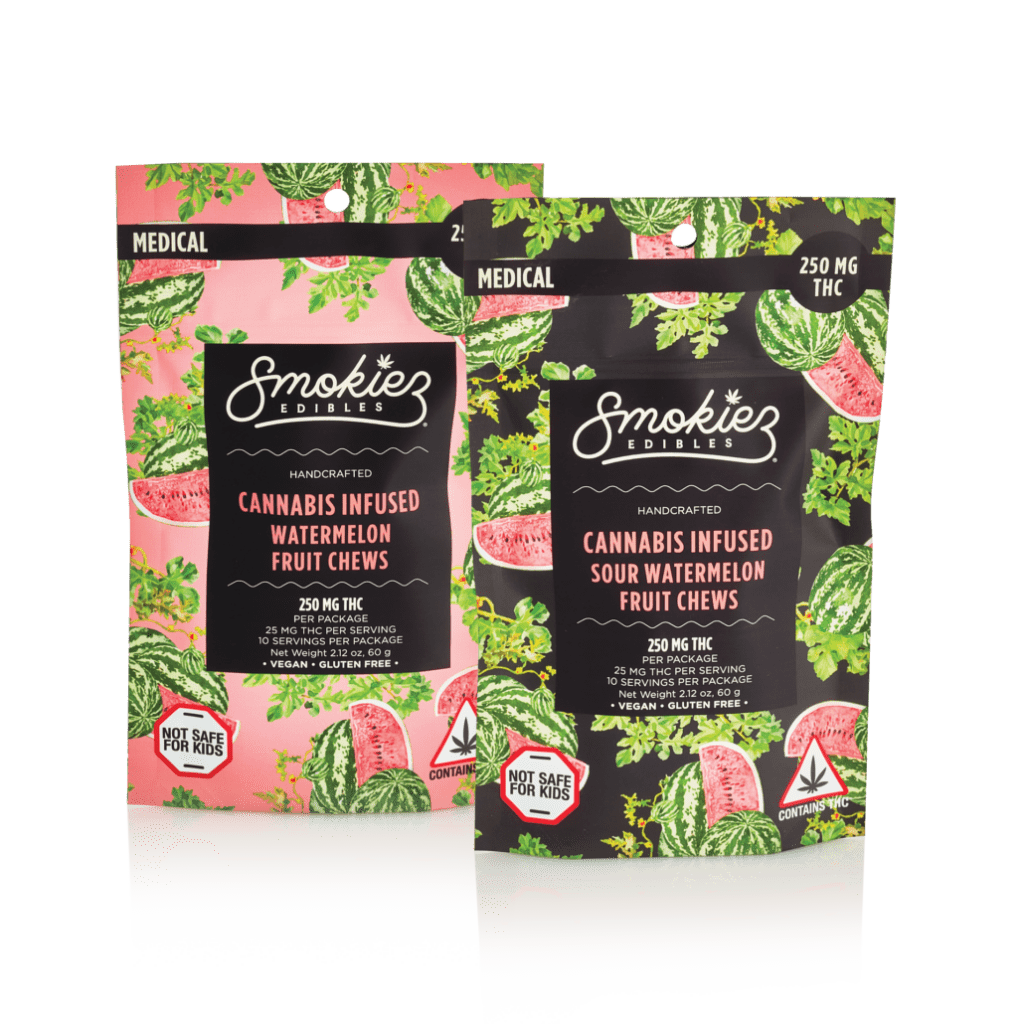 Two packages of Smokiez Edibles cannabis-infused fruit chews are shown. The package on the left is pink and labeled "Watermelon Fruit Chews," while the one on the right is black and labeled "Sour Watermelon Fruit Chews." Both packages indicate 250 mg THC per package, with 25 mg THC per serving and 10 servings per package. The packaging features watermelon and leafy green designs, along with warnings that the product is not safe for kids and contains THC.